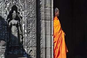 Monk with Buddhist statues in Banteay Kdei, UNESCO World Heritage site