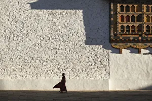 Monk Prints: Monk walks through the courtyard of Rinpung Dzong (Monastery) also called Paro Dzong