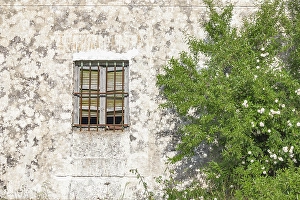 Montefrio Prints: Montefrio, Granada, Andalusia, Spain. A barred window on an old stucco building