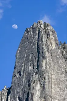 Images Dated 28th March 2007: The moon rises and shines through the clouds above Cathedral Rock - Yosemite National Park