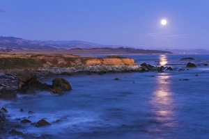 Shoreline Prints: Full moon rising over Piedras Blancas elephant seal rookery, San Simeon, California USA