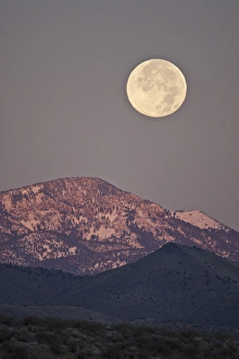 Socorro Prints: Full moon setting over snow-covered Magdelena Mountains at Socorro, New Mexico