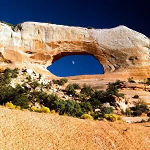 Moon in Wilson Arch on highway 191 between Moab and Monticello Utah adjacent to Needles