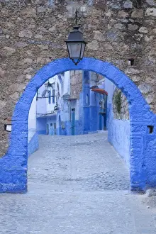 Moroccan Prints: Morocco, Chefchaouen. A blue arch and quiet street entering the medina of the village
