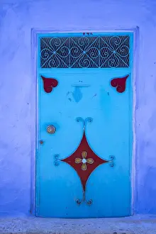 Moroccan Prints: Morocco, Chefchaouen. A traditional metal painted door with red heart-like motifs