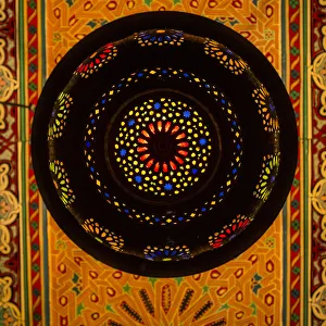 Décor Prints: Morocco. A graphic silhouetted detail of a metal Moroccan lamp in a ceiling of a
