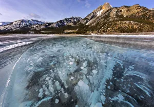 Images Dated 23rd January 2018: Mount Abraham at sunrise with methane ice bubbles under clear ice on Abraham Lake near Nordegg