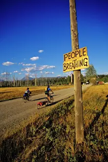 Mountain Bike Prints: Mountain bikers head into Polebridge while riding on the Great Divide Route in Montana