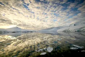 Ice Flow Prints: Mountain Ranges around Port Lockeroy with evening light and breaking clouds