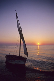 Mozambique Prints: Mozambique: Bazaruto Archipelago, Benguerra Island, local fishing boat, sunset