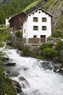 Images Dated 17th June 2010: Mulegns, Switzerland. Stream and house in Mulegns