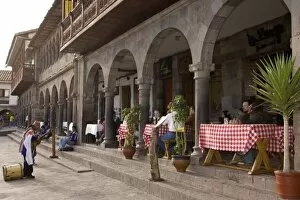 Musician playing for tourists having lunch on patio, Plaza de Armas, Cuzco, Peru