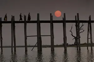 Burma Prints: Myanmar, Amarapura. Buddhist monks crossing U Bein Bridge at sunset