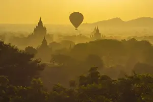 Buddhism Prints: Myanmar. Bagan. Hot air balloons rising over the temples of Bagan