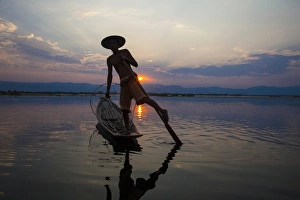 Paddle Prints: Myanmar, Inle Lake. Fisherman rowing at sunset