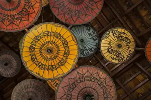 Myanmar, Mandalay. Umbrellas hanging from restaurant ceiling