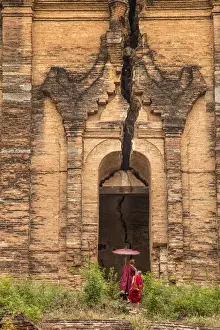 Burma Prints: Myanmar, Mingun. Two novice Buddhist monks in front of temple entrance. Credit as
