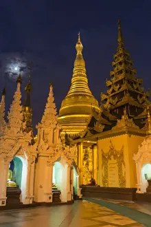 Gilded Prints: Myanmar, Yangon. Golden stupa and temples of Shwedagon Pagoda at night with moon