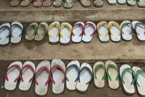 Buddhism Prints: Myanmar, Yangon. Shoes lined up outside a monastery in Yangon