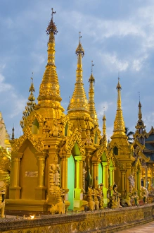 Images Dated 21st November 2014: Myanmar. Yangon. Shwedagon Pagoda. Gold spires glow in the twilight