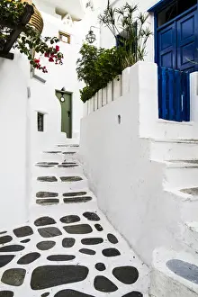Bougainvilla Prints: Mykonos, Greece. Rock and stucco patio and stairs leads to painted doors