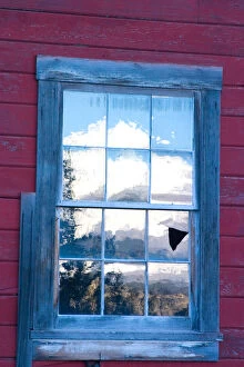 N.A. USA, Alaska. A reflection of the Wrangell Mountains in the window of the historic