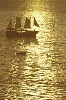 N.A. USA, Hawaii, Maui Sailboat in golden sea at sunset