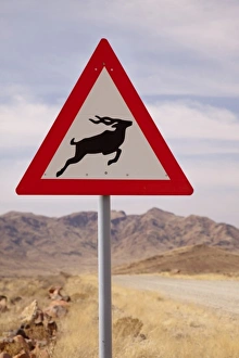 Private Prints: Namibia, Namib Desert, NamibRand Nature Reserve. Kudu crossing caution sign