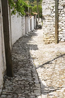 Images Dated 11th July 2006: A narrow cobble stone street lined with white stone houses. Berat upper citadel old walled city