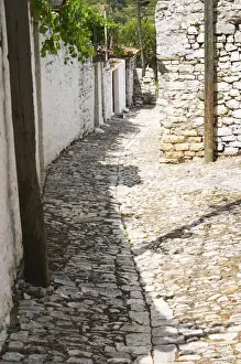 Citadel Prints: A narrow cobble stone street lined with white stone houses