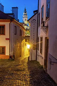 Images Dated 10th January 2023: Narrow cobblestone streets at dusk with Castle Tower in historic Cesky Krumlov