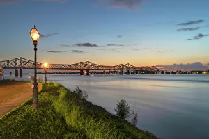Prints of Natchez-Vidalia Bridge over the Mississippi River after sunset. Seen from Natchez, Mississippi Images Dated 2022 May: Natchez-Vidalia Bridge over the Mississippi River after sunset
