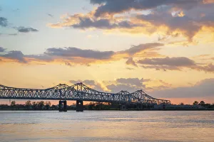 Prints of Natchez-Vidalia Bridge over the Mississippi River at sunset. Seen from Natchez, Mississippi Images Dated 2022 May: Natchez-Vidalia Bridge over the Mississippi River at sunset