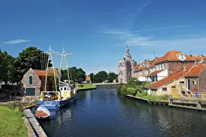 Netherlands, Enkhuizen, Classic Dutch vessels in the canal, Drommedaris Tower in