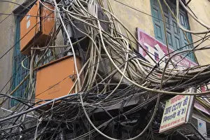 New Delhi Prints: New Delhi, mass of wires for electronics and telecommunications strung between businesses