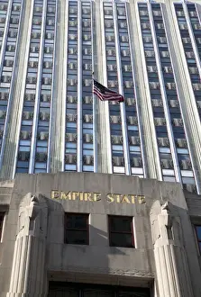 Inti St Clair Prints: New York, NY, USA - An American flag is flying above the entrance to the Empire State