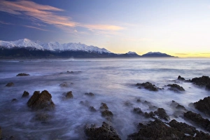 Foreshore Prints: New Zealand, South Island, Kaikoura, Waves on Rocks and Seaward Kaikoura Range at Dawn