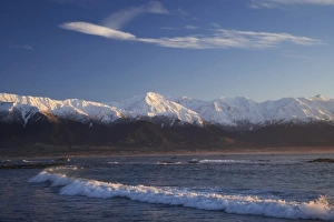 New Zealand, South Island, Kaikoura, Waves and Early Light on Seaward Kaikoura Range