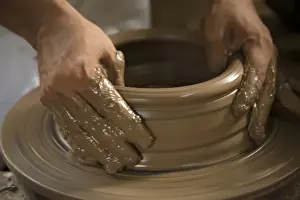 Images Dated 5th November 2008: Nicaragua, Catarina. Potters hands creating clay pottery on spinning wheel