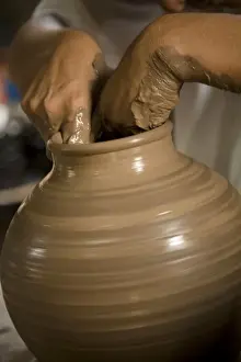 Granada Prints: Nicaragua, Catarina. Potters hands creating clay pottery on spinning wheel