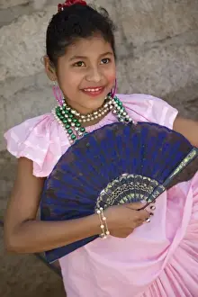 Granada Prints: Nicaragua, Granada. Girl with fan in traditional dress after dance in Villa Esperanza barrio