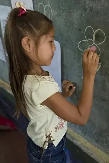 Granada Prints: Nicaragua, Granada. Girl writing on blackboard in school classroom in Santa Ana de Malacos