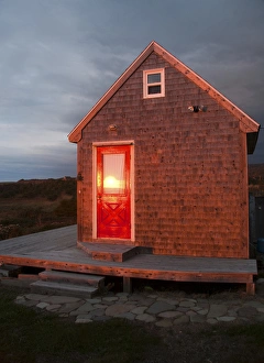 North America, Canada, Nova Scotia, Cape Breton, Cabot Trail Cottage at sunset