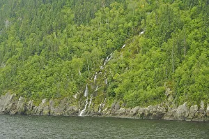 North America, Canada, Quebec, Saguenay. View from the water of a waterfall on