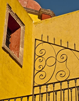 Images Dated 28th December 2011: North America, Mexico, Guanajuato. Wrought iron fence against a yellow church wall