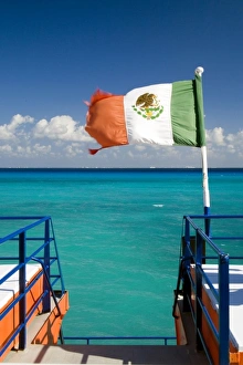 Mayan Riviera Prints: North America, Mexico, Quintana Roo, Cozumel. The Mexican flag flying off the stern