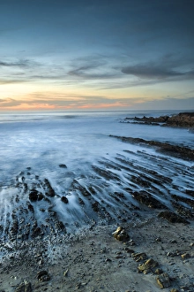 North America, USA, California. Sunset on rock formations with ocean at Montana de Oro State Park
