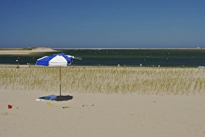 North America, USA, Massachusetts, Chatham. An umbrella and pails on the beach