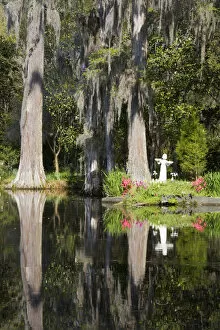 Images Dated 25th March 2007: North America, USA, South Carolina, Charleston. Garden Statue and Blooming Azaleas