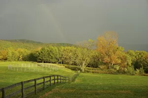 North America, USA, Vermont, Windsor County. Rainbow over a field in autumn